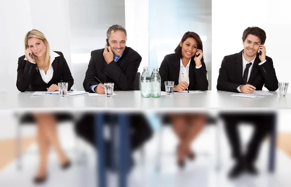 Business talking on the phones at the meeting — Stock Photo, Image