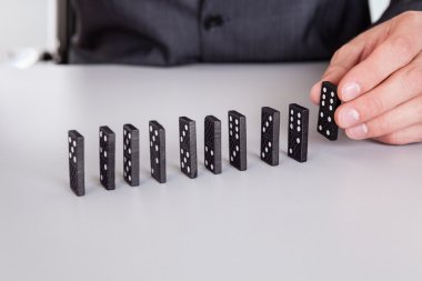 Businessman playing domino clipart