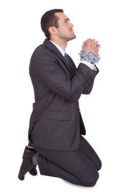 Businessman bound in chains begs for freedom clipart
