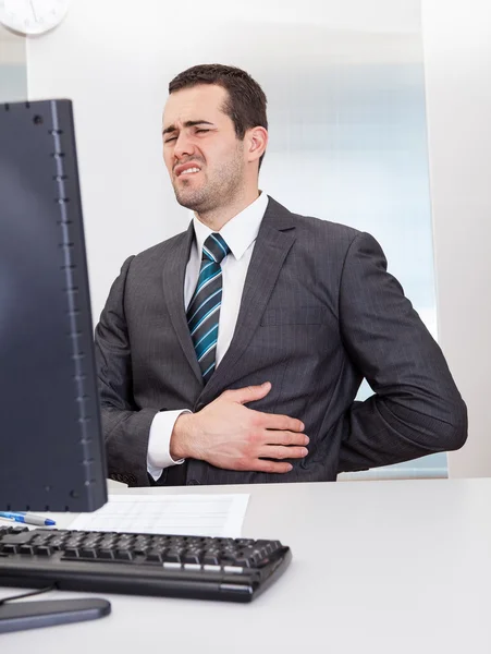 Businessman suffering from pain — Stock Photo, Image
