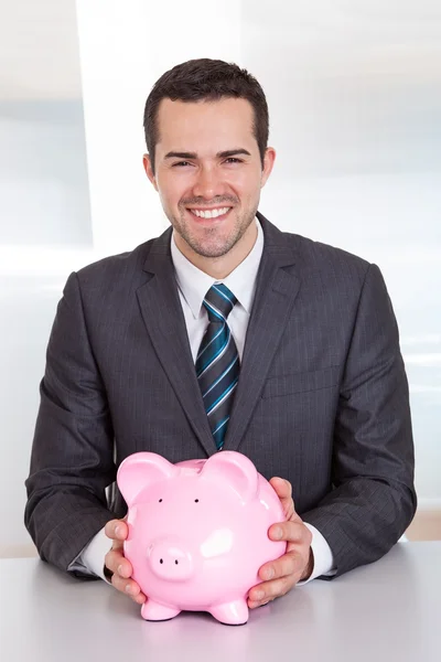 Businessman holding piggybank — Stock Photo, Image