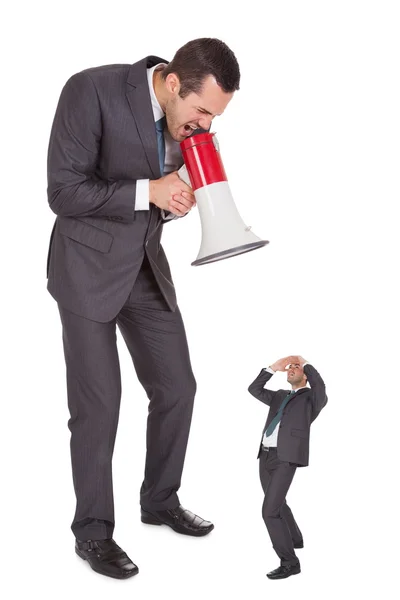 Boss screaming in megaphone at employee — Stock Photo, Image