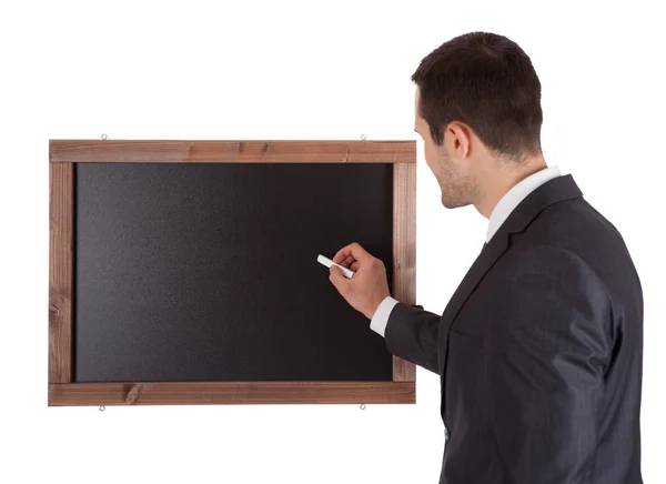 Businessman writing on blackboard — Stock Photo, Image