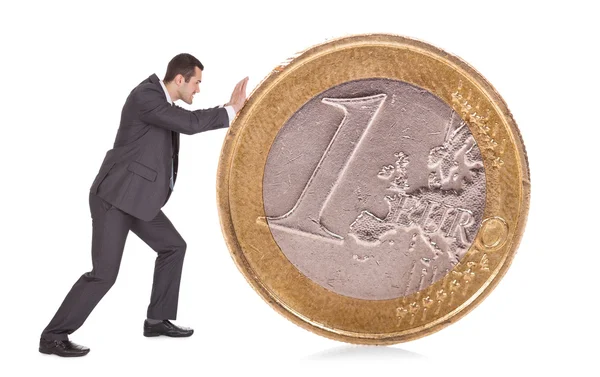 Sukcesy biznesmen pchanie monety 1 euro — Zdjęcie stockowe