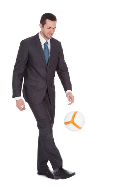 Businessman playing with football — Stock Photo, Image