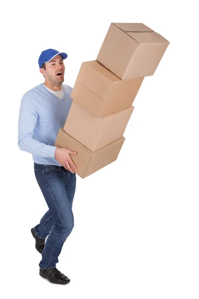 Jovem homem de entrega com caixas caindo — Fotografia de Stock