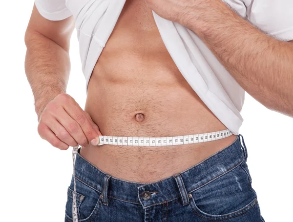 Homem muscular medindo cintura — Fotografia de Stock