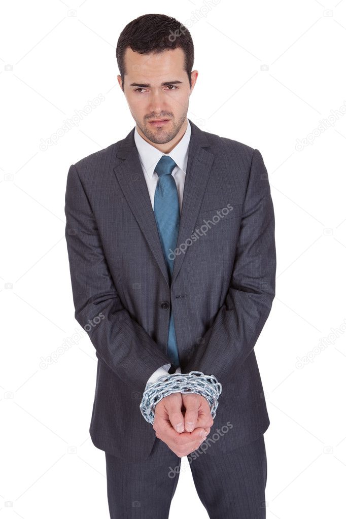 Businessman hands bound in chains