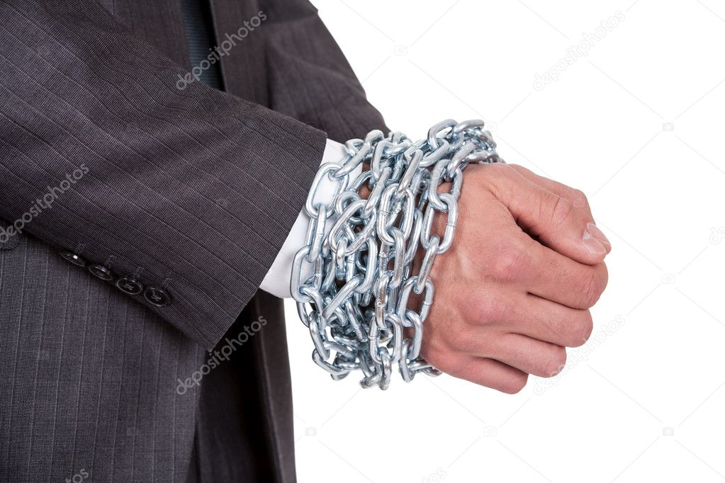Businessman hands bound in chains