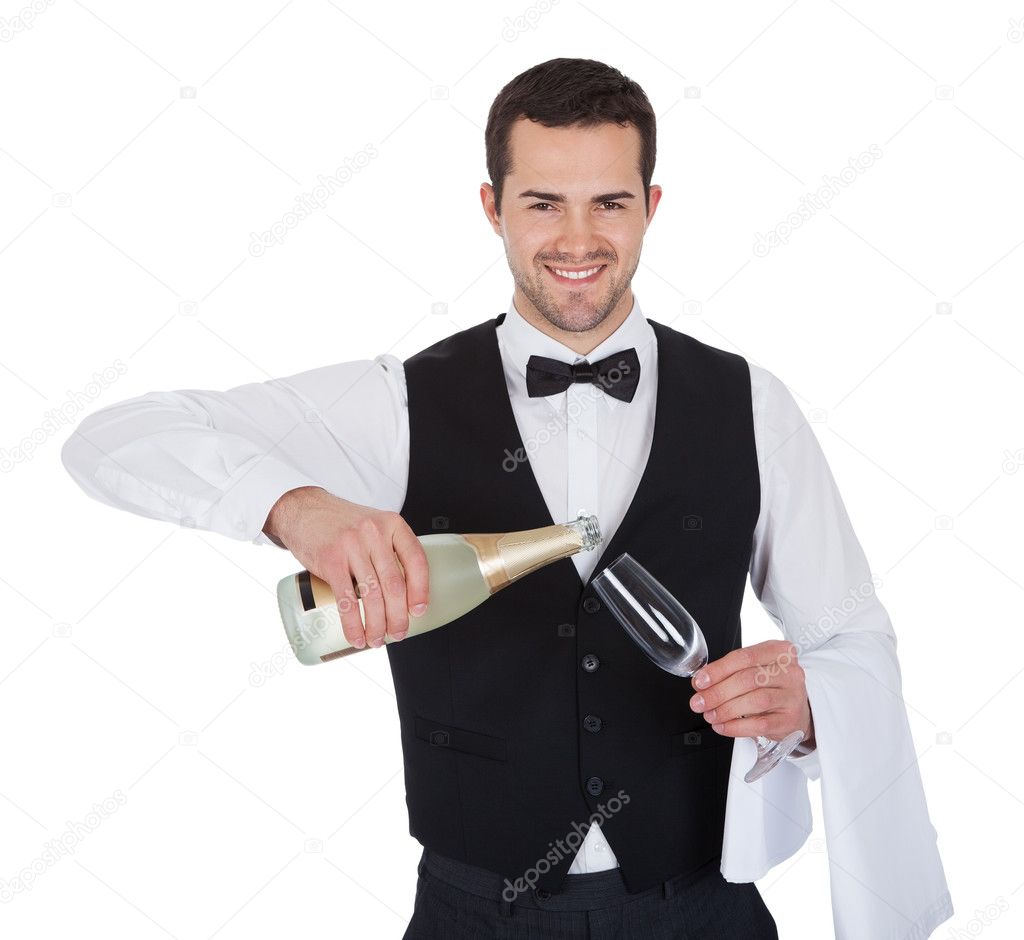Portrait of butler pouring champagne into glass