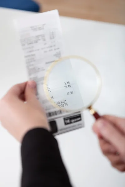 stock image Businesswoman looking at check trough the loupe