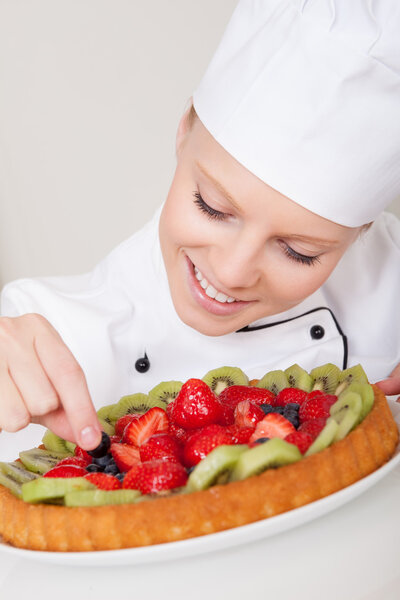 Beautiful chef woman making cake