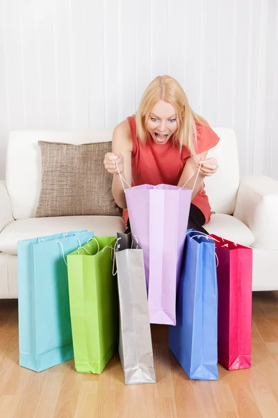 Krásná mladá žena kontrolu nákupní tašky — Stock fotografie