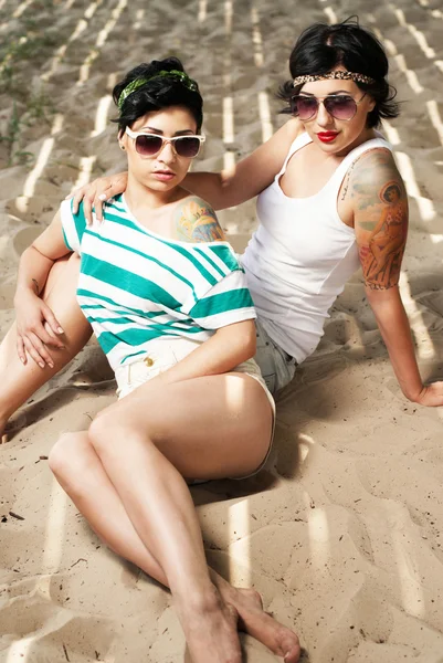 stock image Two adorable women with tattoos wearing sunglasses