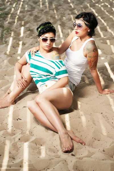 stock image Two adorable women with tattoos wearing sunglasses