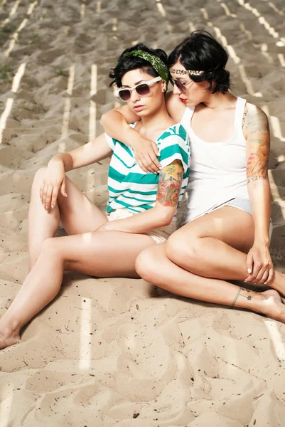 stock image Two adorable women with tattoos wearing sunglasses