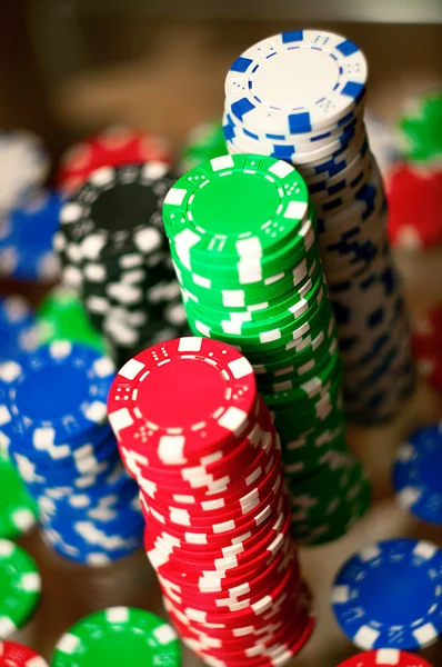Red, blue, green and black casino tokens — Stock Photo, Image