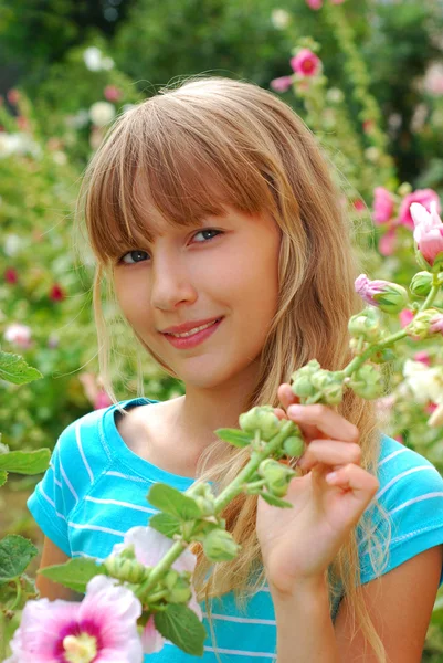 Young girl in the garden of mallows — Stock Photo, Image