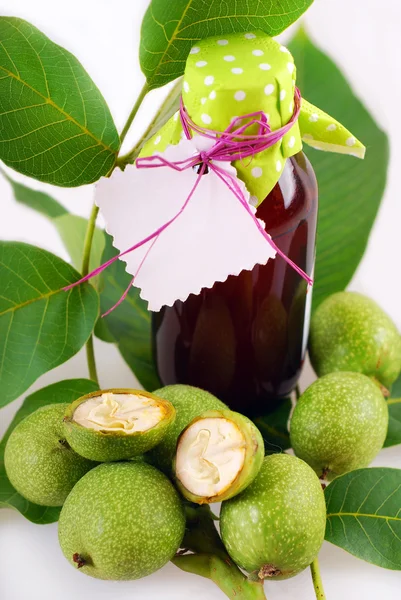 Fresh green walnuts and liqueur — Stock Photo, Image