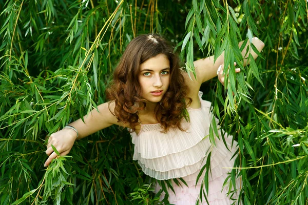 The girl in willow branches — Stock Photo, Image