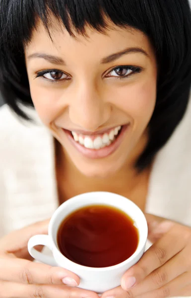 Woman looks up with cup — Stock Photo, Image