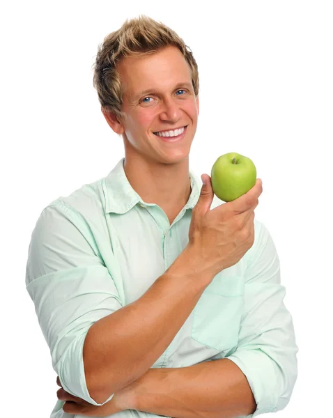 Handsome young man holding an apple — Stock Photo, Image
