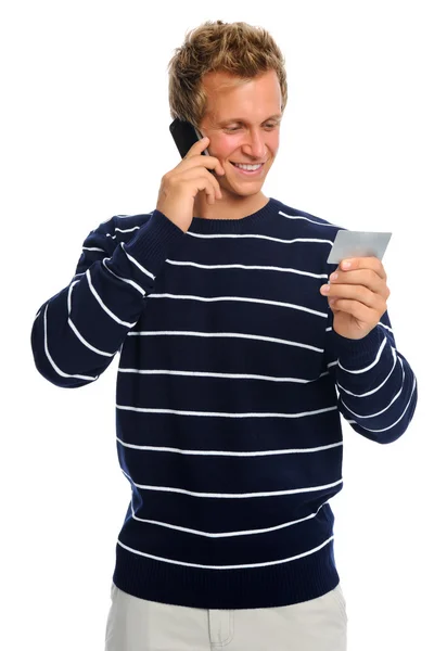 Homem atraente lendo o número do cartão de crédito — Fotografia de Stock