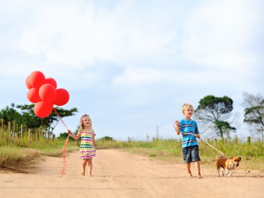 Cute blond children outdoors in the sun clipart