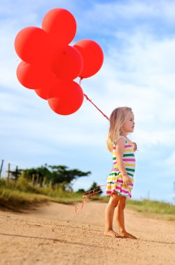 Cute young child with balloons clipart