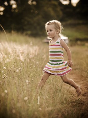 Happy child playing outdoors clipart