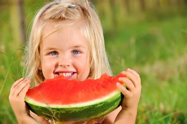 Young girl smiles with watermelon — Stock Photo, Image