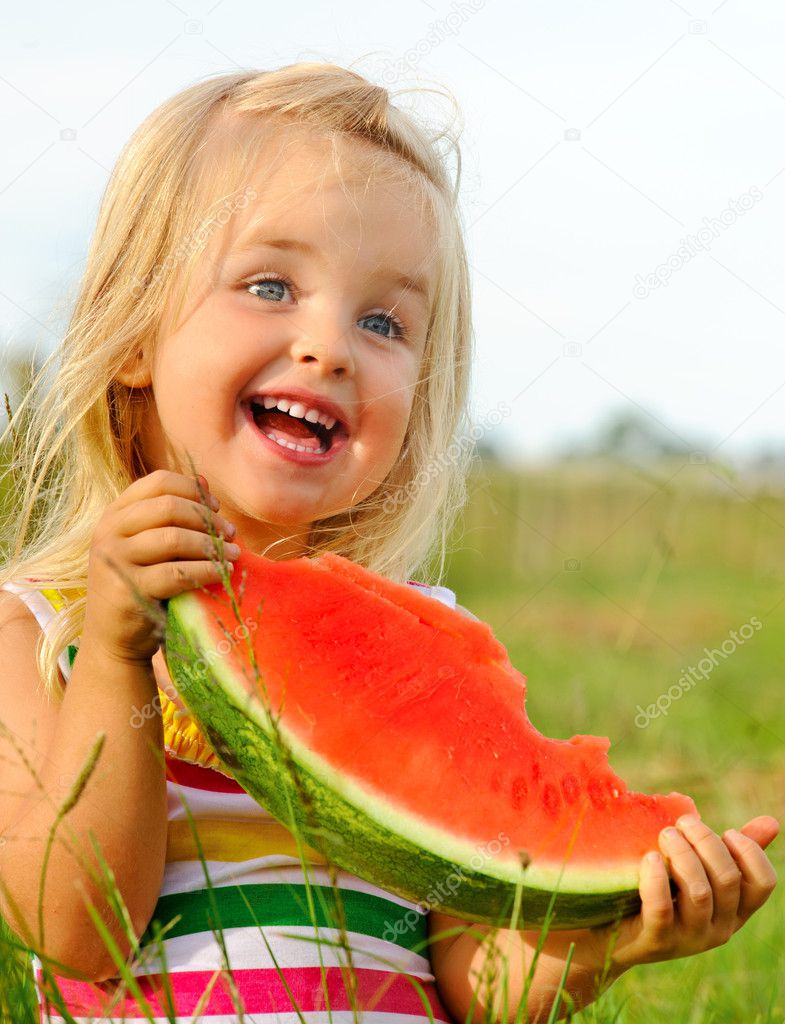Cute blond girl happy with watermelon