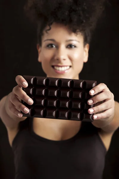Woman with a chocolate bar — Stock Photo, Image