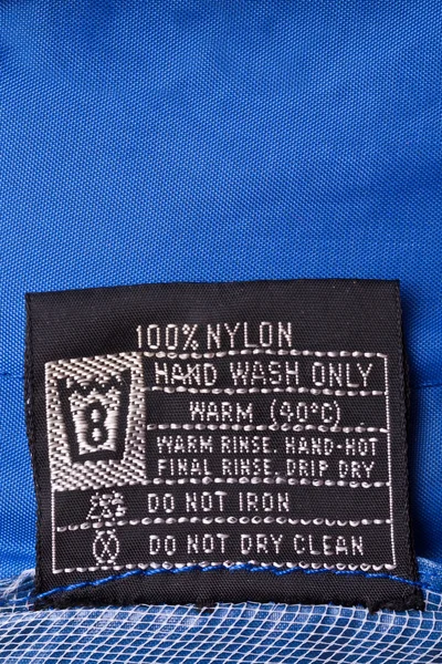 Clothing label on raincoat — Stock Photo, Image