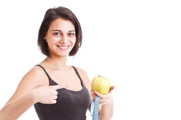 Девушка держит яблоко и измерительную ленту — стоковое фото