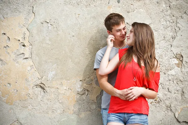 Young couple is standing grunge wall Royalty Free Stock Images