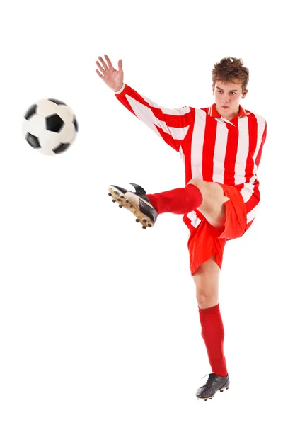 Футболист пинает мяч Лицензионные Стоковые Изображения