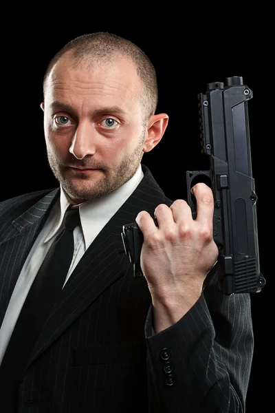 Uomo con una pistola in mano Foto Stock