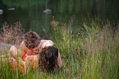 Couple lying on shore clipart