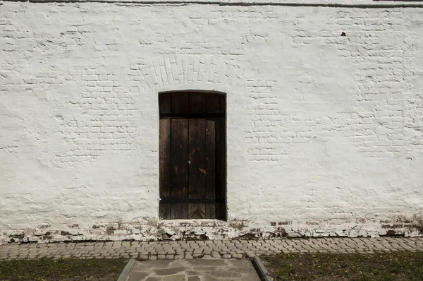 Old door in the brick wall — Stock Photo, Image