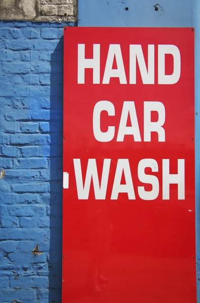 Bright red hand car wash sign — Stock Photo, Image