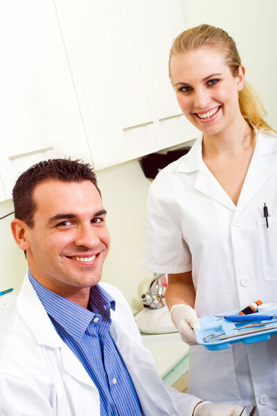 Friendly dentist and dental assistant