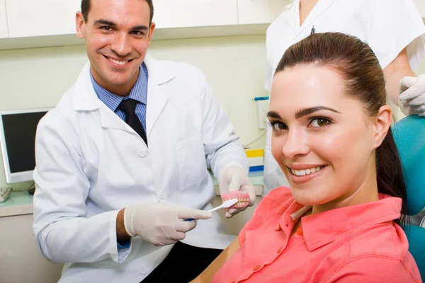 Dentist demonstrate tooth brush in his practice Stock Image