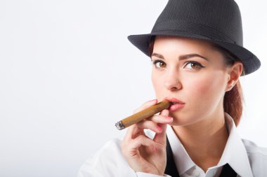 Woman dressing in man's clothing holding a cigar clipart