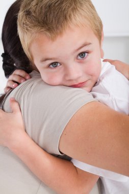 Cute little boy hugging mother clipart