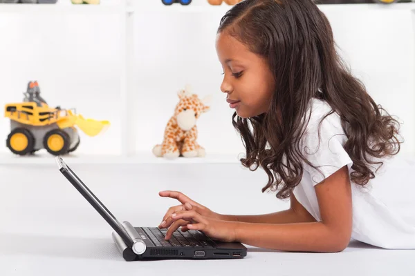 African american girl playing with laptop — Stock Photo, Image