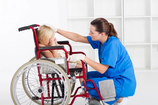 Caring medical worker comforting little patient — Stock Photo, Image