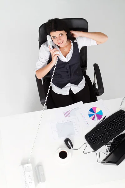 Businesswoman talking on telephone in office — Stock Photo, Image