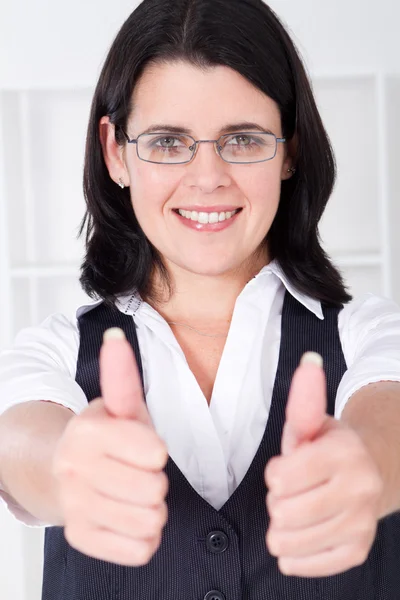 Friendly businesswoman giving thumbs up — Stock Photo, Image