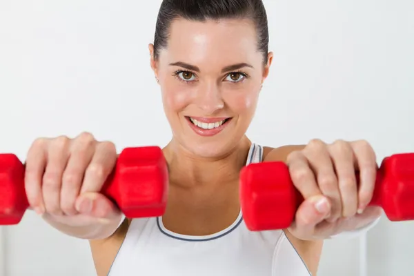 Woman exercising with dumbbell — Stock Photo, Image